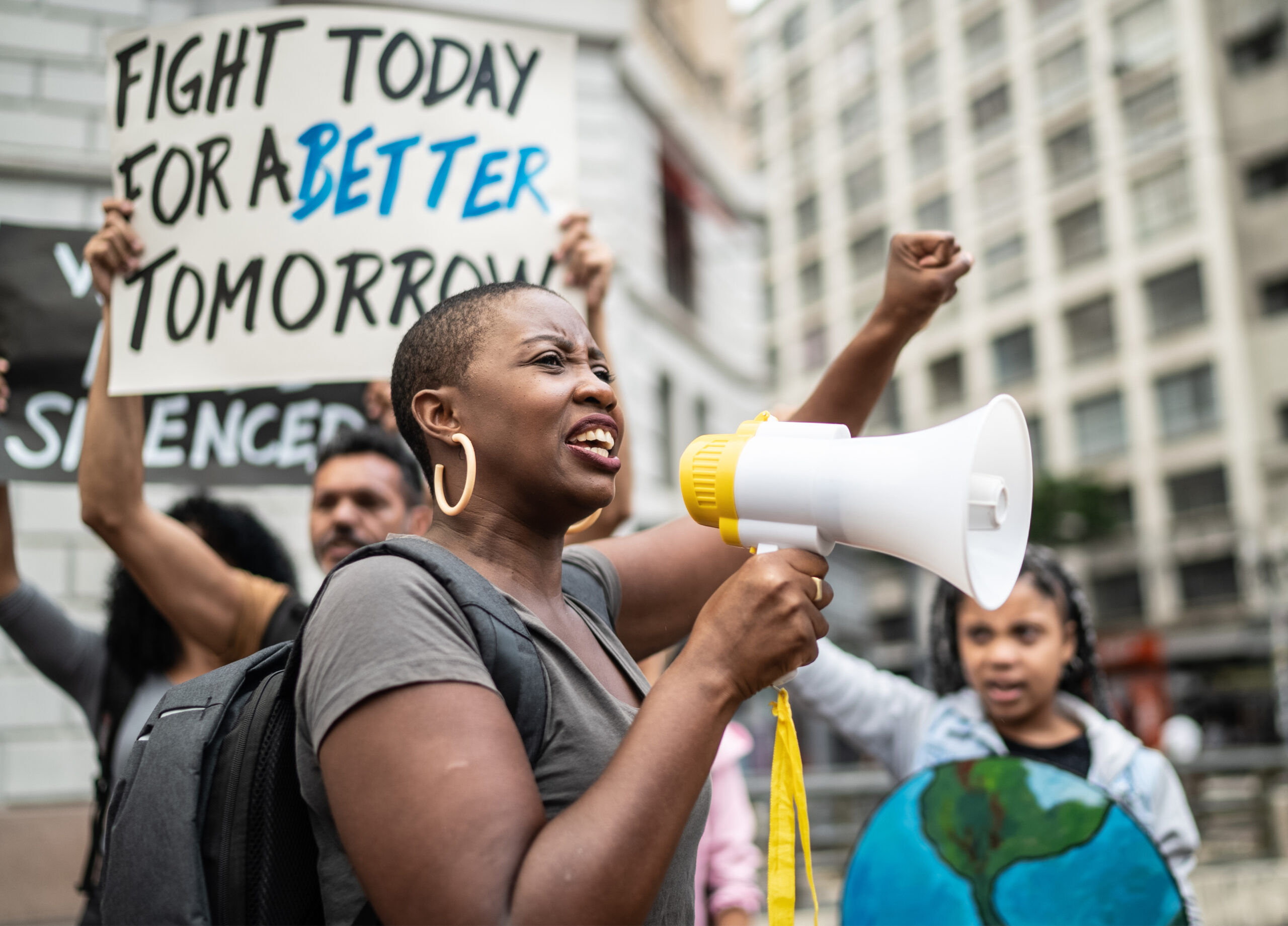 Protest Black woman leading a protest using a megaphone.
