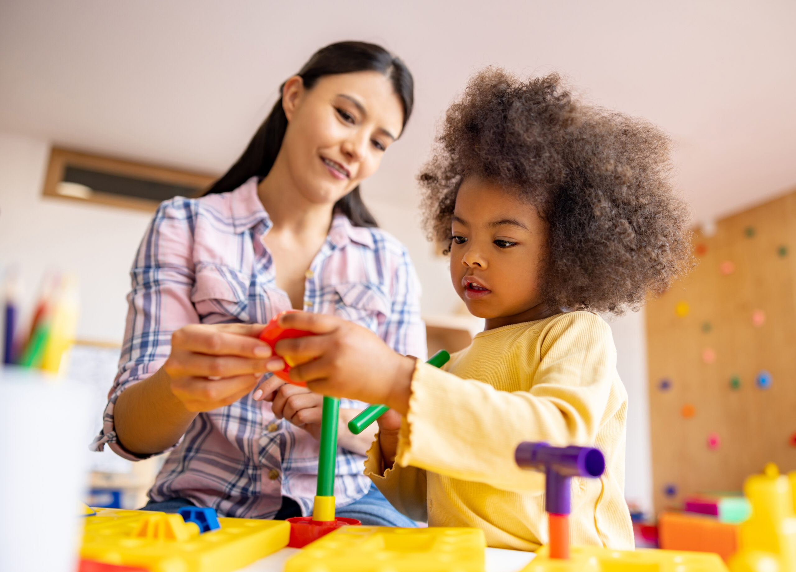 Schoolgirl playing in the classroom with some building blocks Girl playing with building blocks